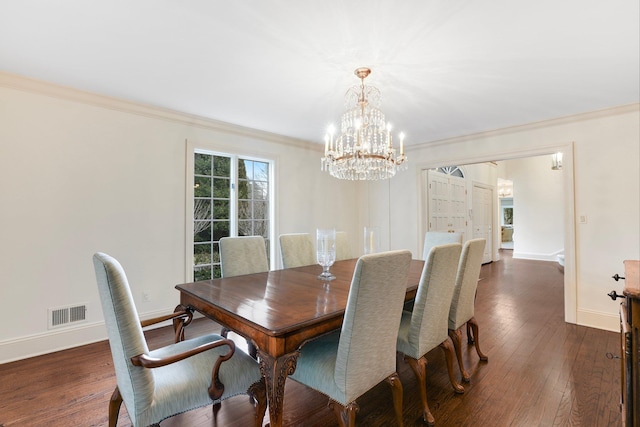 dining space featuring dark hardwood / wood-style flooring, crown molding, and a notable chandelier