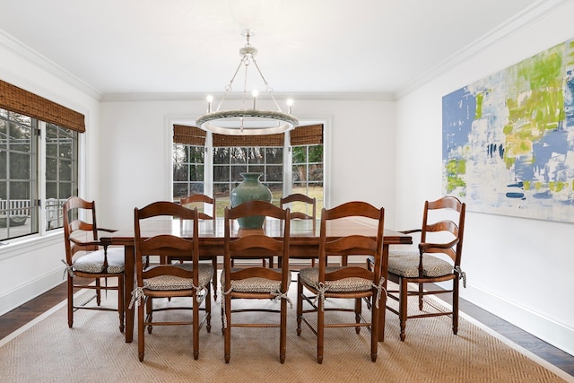 dining area featuring wood-type flooring, a wealth of natural light, and ornamental molding