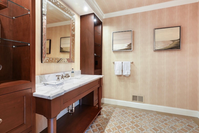 bathroom featuring sink and crown molding