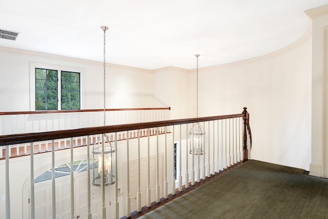 corridor with dark carpet and crown molding