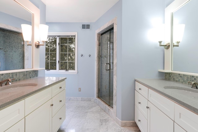 bathroom featuring decorative backsplash, vanity, and a shower with door