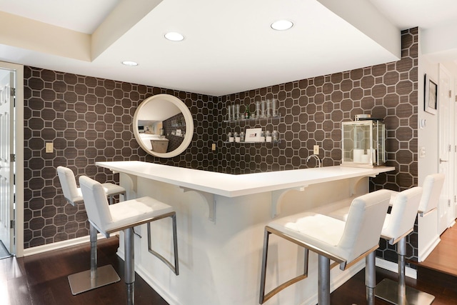 bar featuring dark hardwood / wood-style flooring