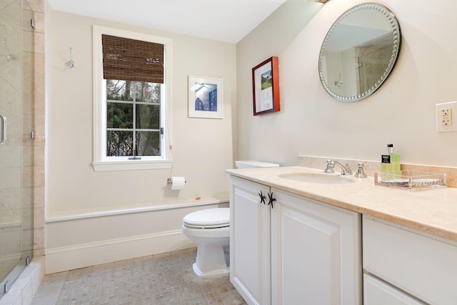 bathroom featuring toilet, vanity, tile patterned flooring, and a shower with shower door