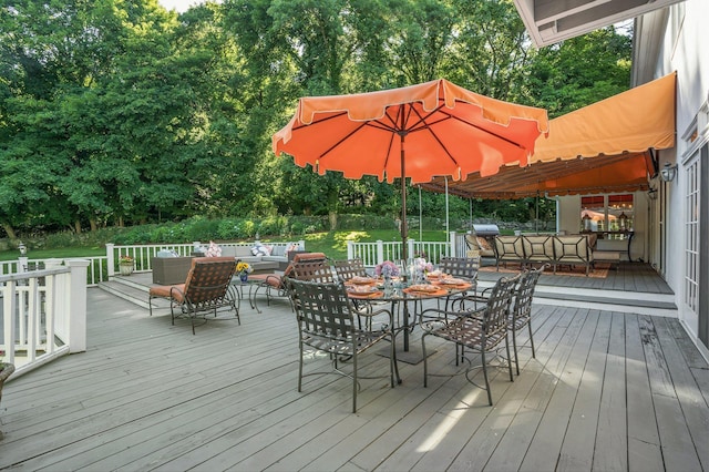 wooden deck featuring a grill and an outdoor living space