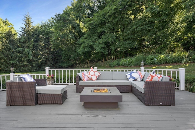 deck with an outdoor living space with a fire pit