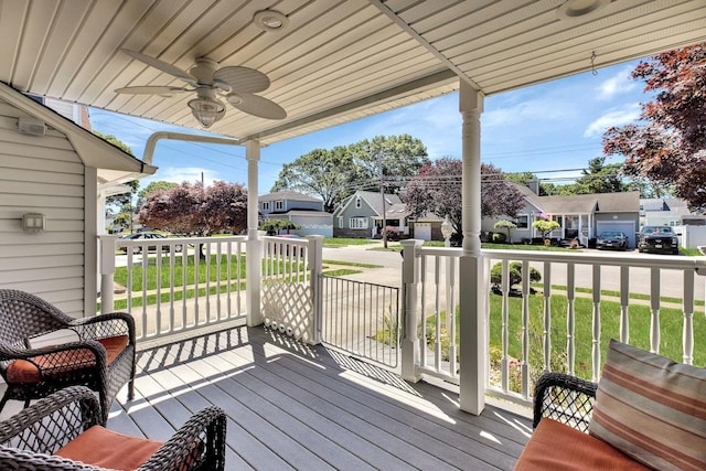 wooden terrace with ceiling fan and a porch