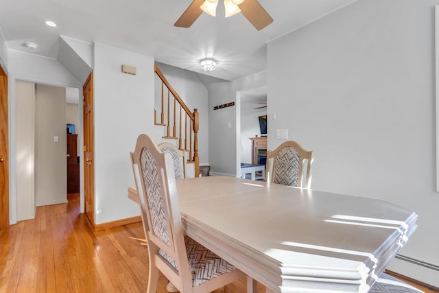 dining space with ceiling fan and light hardwood / wood-style flooring