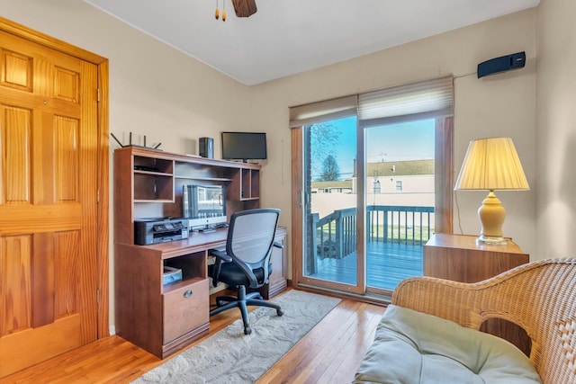 office with light hardwood / wood-style floors and ceiling fan