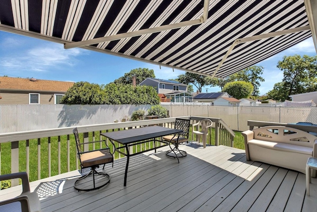 wooden terrace featuring a yard