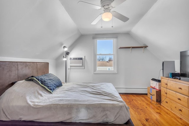 bedroom with a baseboard radiator, light hardwood / wood-style floors, a wall mounted AC, vaulted ceiling, and ceiling fan