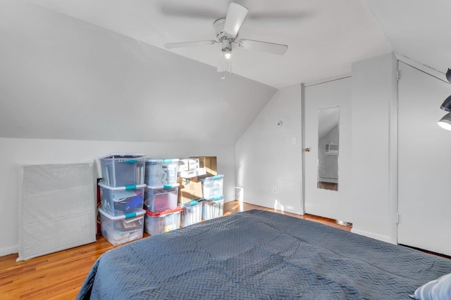 bedroom with lofted ceiling, hardwood / wood-style flooring, and ceiling fan