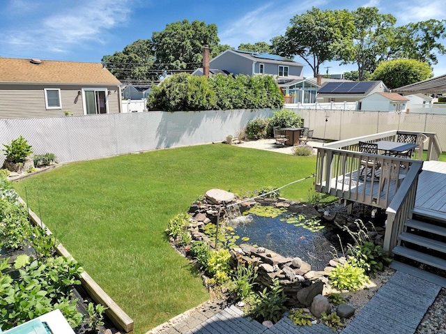 view of yard featuring a wooden deck and a patio