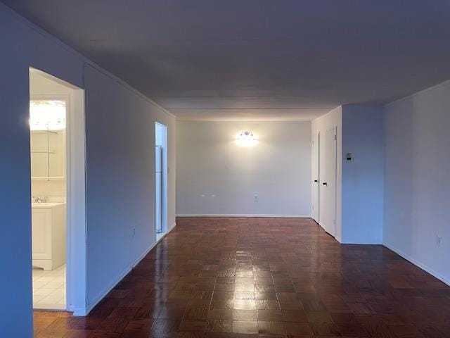 unfurnished room featuring dark parquet flooring