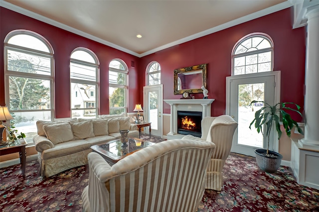 living room with crown molding and ornate columns