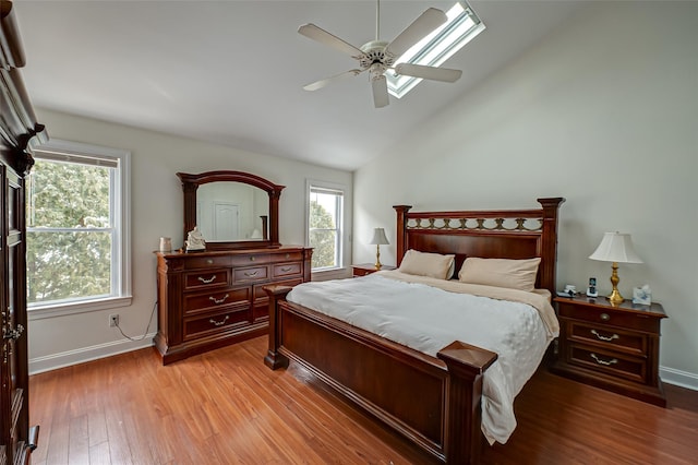 bedroom featuring light wood-type flooring, ceiling fan, and lofted ceiling