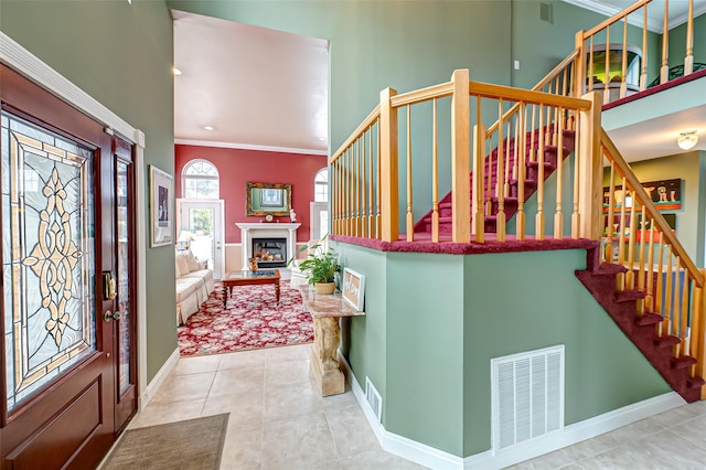 foyer featuring crown molding and light tile patterned flooring