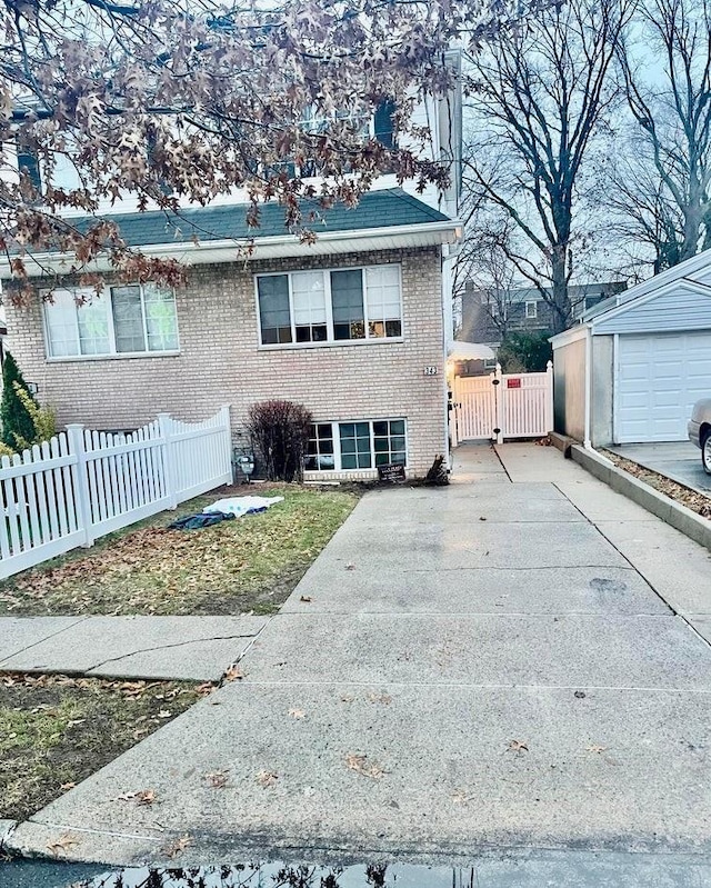 view of front of property featuring a garage and an outbuilding