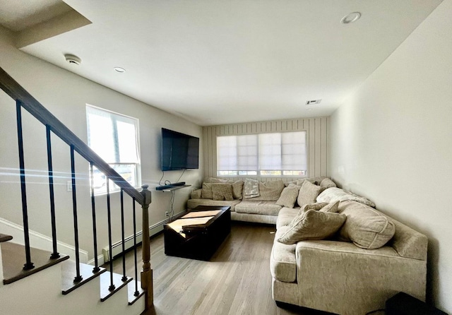 living room with hardwood / wood-style floors and a baseboard radiator