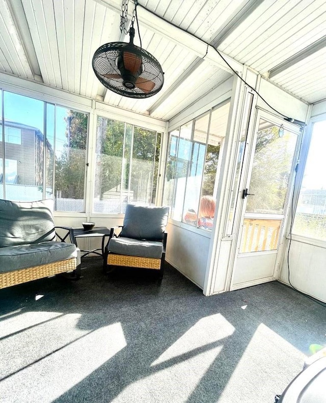 sunroom featuring ceiling fan