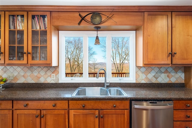 kitchen with pendant lighting, sink, stainless steel dishwasher, and decorative backsplash