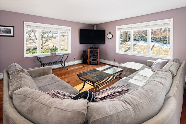 living room featuring a baseboard heating unit and hardwood / wood-style floors