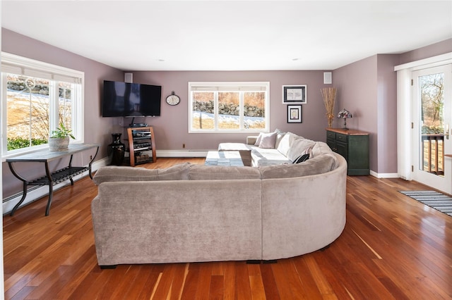 living room with plenty of natural light and dark wood-type flooring