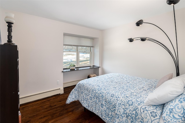 bedroom with a baseboard heating unit and dark hardwood / wood-style floors