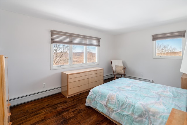 bedroom featuring a baseboard heating unit and dark hardwood / wood-style floors