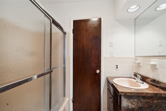 bathroom with an enclosed shower and vanity