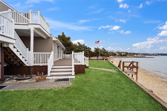 view of yard with a deck with water view