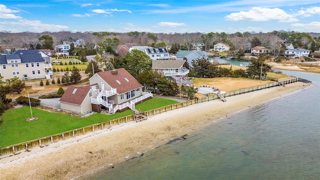 birds eye view of property with a water view and a beach view