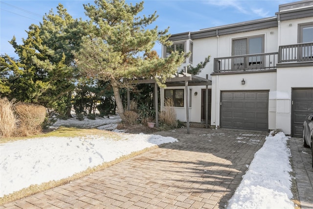 view of front of property with a balcony and a garage