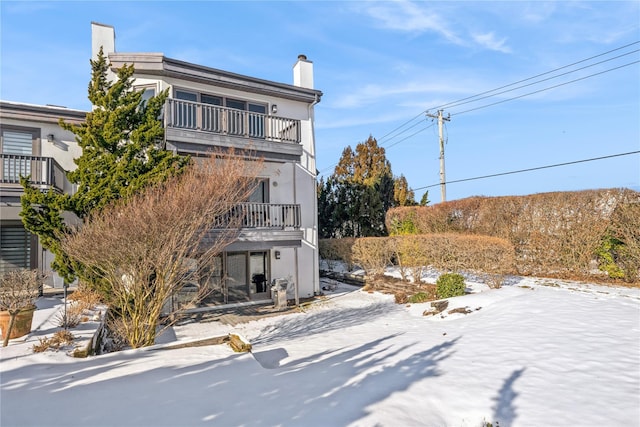 view of side of home with a balcony