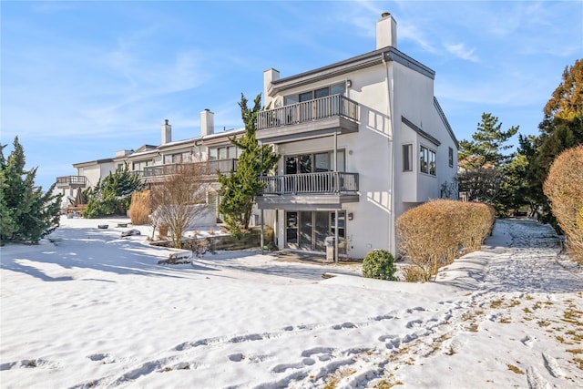 snow covered house with a balcony