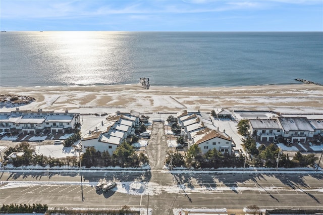 birds eye view of property with a water view and a view of the beach