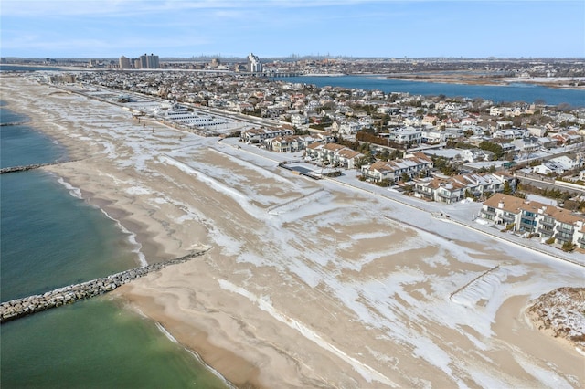 drone / aerial view featuring a water view and a view of the beach