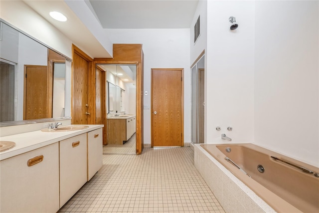 bathroom with tile patterned floors, vanity, and shower with separate bathtub