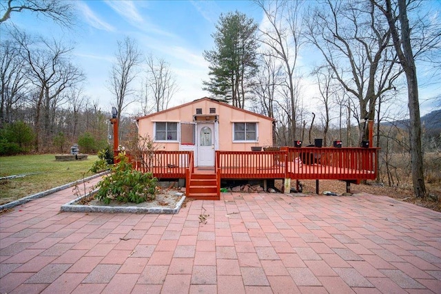 view of front of property with a front lawn and a deck