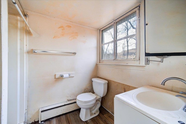 bathroom featuring toilet, baseboard heating, wood-type flooring, and vanity