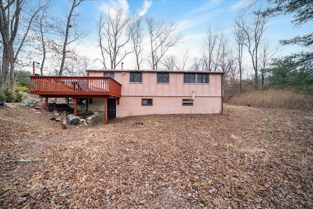 rear view of house featuring a deck