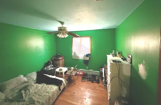 bedroom with ceiling fan and wood-type flooring