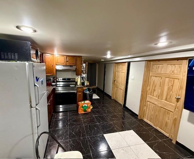 kitchen with white fridge and stainless steel range with electric cooktop