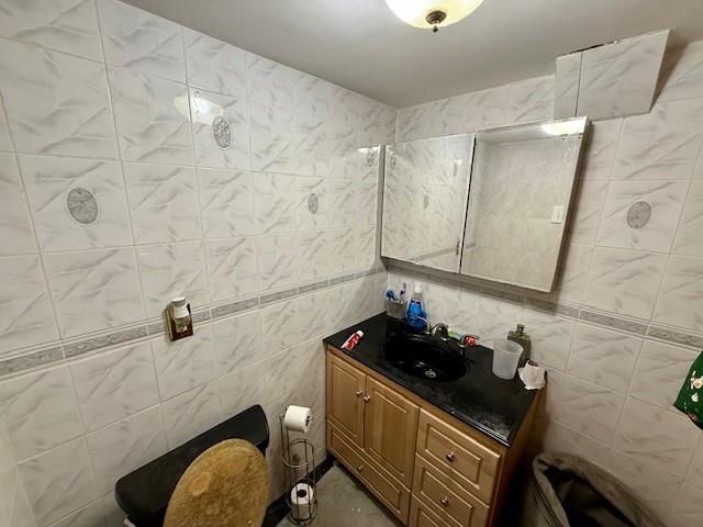 bathroom featuring tile walls and vanity