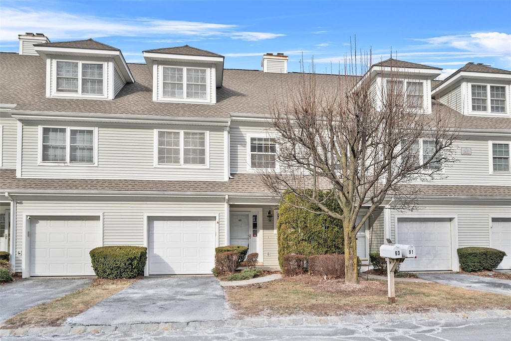 multi unit property featuring a garage