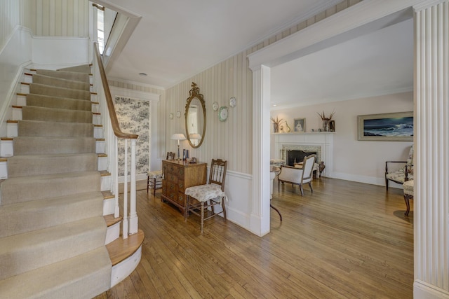 foyer featuring crown molding and hardwood / wood-style floors