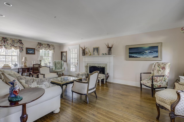 living room with ornamental molding, hardwood / wood-style floors, and a fireplace