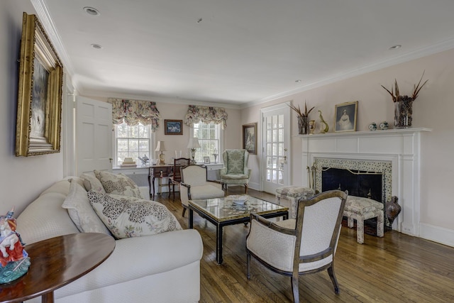 living room with ornamental molding, dark hardwood / wood-style flooring, and a tile fireplace