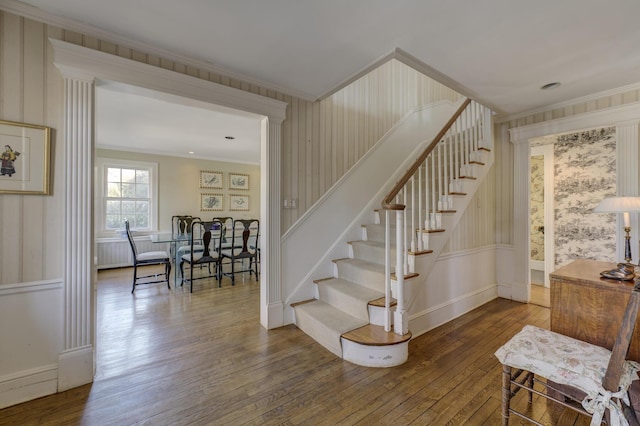 stairway featuring wood-type flooring and ornamental molding