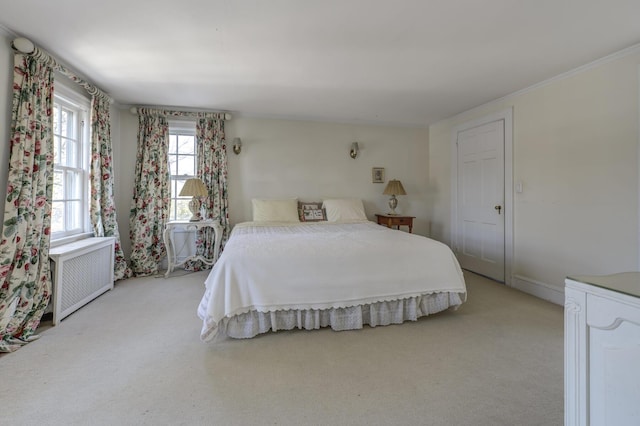 bedroom featuring radiator and light colored carpet