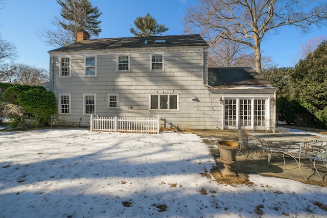 snow covered property with a patio area